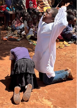 Children reenacting Jesus praying in the garden