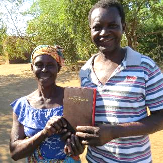 James Mwanza and his wife holding a copy of God’s Word