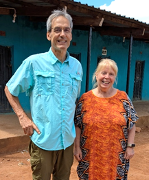 Ken and Sue Sawka standing outside a building in Zambia