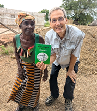 Ken Sawka with Dee Sakala holding the Gospel of Mark in Toka-Leya