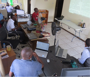 Toka-Leya translation team reviewing New Testament passages in their office