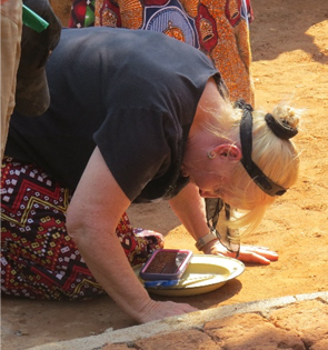 Woman kneeling in prayer outdoors