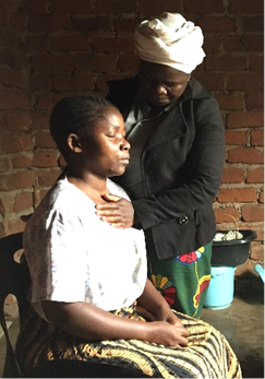 Priscilla praying for a woman who needed healing