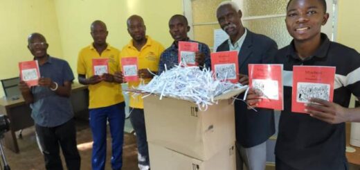 Toka-Leya team holding copies of the Book of Acts