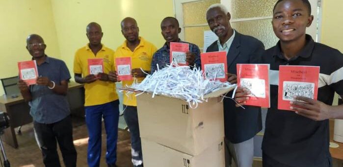 Toka-Leya team holding copies of the Book of Acts