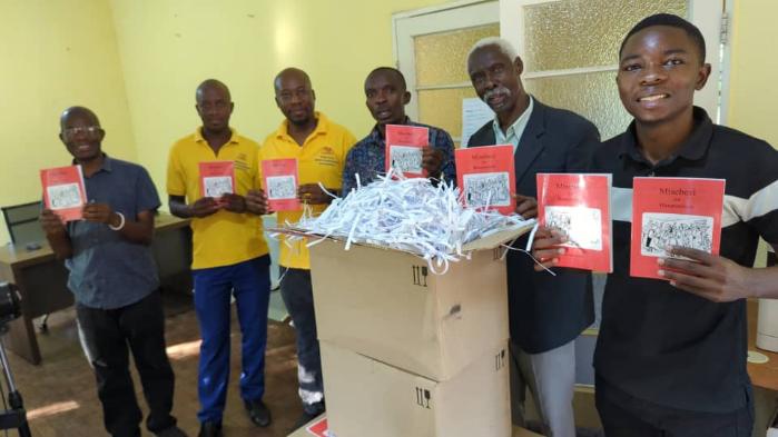Toka-Leya team holding copies of the Book of Acts