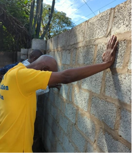 Team member praying at the wall of the new office property