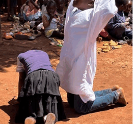 Children reenacting Jesus praying in the garden