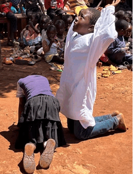 Children reenacting Jesus praying in the garden
